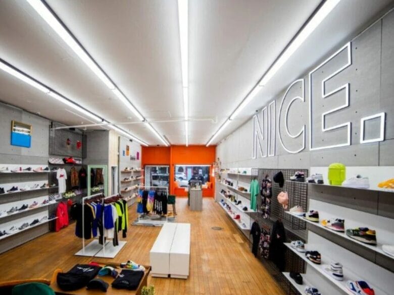 Interior de la tienda Nice Kicks en San Francisco con estanterías de sneakers y ropa streetwear.