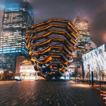 lighted building near body of water during night time