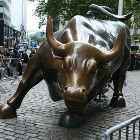 a statue of a bull on a brick street