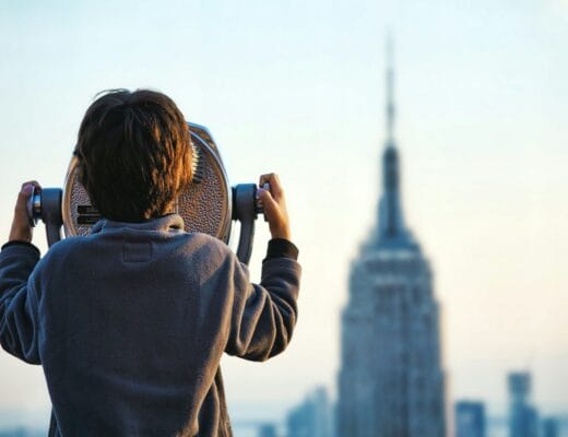 child looking at Empire State building through tower viewer